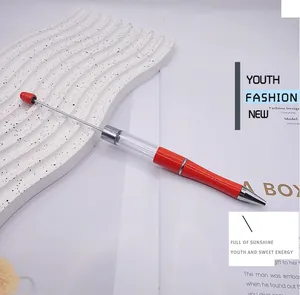 Close-up of a red DIY empty barrel beadable pen with a long rod for personalized decor