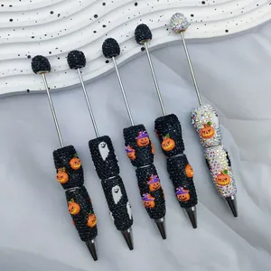 Halloween DIY beaded ballpoint pens featuring rhinestones, ghosts, and pumpkin charms
