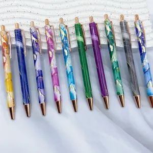 Assorted elegant marble pattern metal ballpoint pens with rose gold trim.
