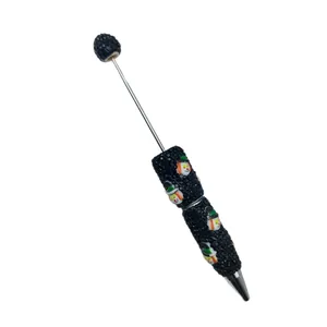 Handmade Halloween themed beaded ballpoint pen featuring snowman charms on black background