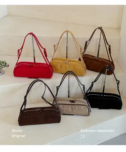Detailed view of suede bowling baguette bags in multiple autumn-inspired colors.