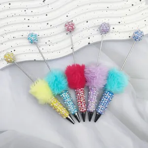 Set of cute colorful beaded ballpoint pens with faux fur balls and rhinestones.