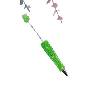 Green mermaid bubble bead ballpoint pen with heart accents on a white background