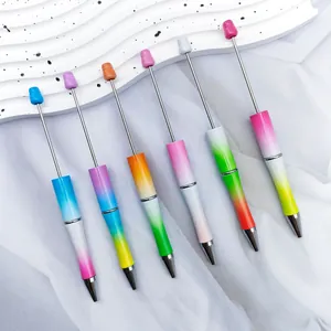 Close-up detail of six DIY beaded ballpoint pens with vibrant pearlescent gradient colors