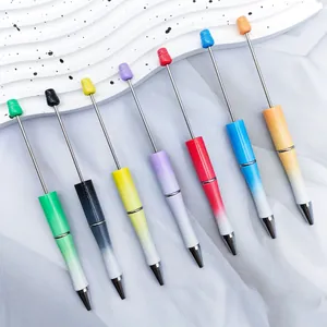Detailed macro view of multi-color gradient pearlescent DIY beaded ballpoint pens