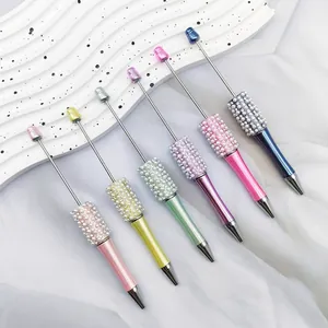 Detail of six colorful beaded ballpoint pens with shiny pearls and decorative rhinestones