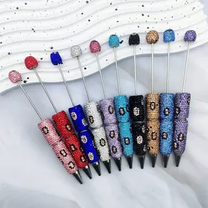 Assorted luxury leopard print rhinestone beaded pens with twist ballpoint mechanism.