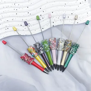 Fan-shaped display of nine DIY beaded ballpoint pens with colorful decorative stones