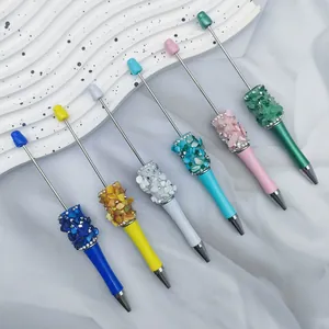 Handmade beaded ballpoint pens with colorful crushed stone decorations and DIY star design