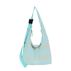 Stylish mint green nylon crescent shoulder bag featuring double front zipper pockets