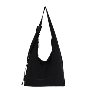 Detail view of black nylon hobo bag with multiple zipper compartments