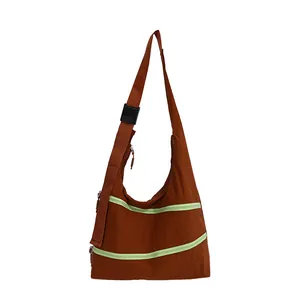 Stylish vintage brown hobo shoulder bag featuring vibrant lime green zipper details.