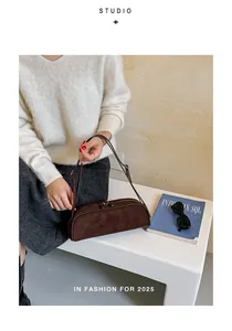 Fashionable brown suede-like bowling bag held by a model in a minimal lifestyle setting