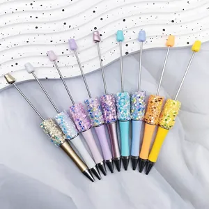 Colorful DIY beadable ballpoint pens with shiny star sequins and rotating mechanism.