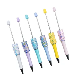 Set of six DIY beaded ballpoint pens with colorful sequins and star glitter on white