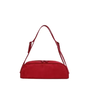 Vibrant red suede-style bowling handbag with elegant baguette silhouette for women.
