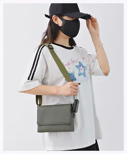 Detalle de un bolso bandolera verde con textura usado por una modelo casual