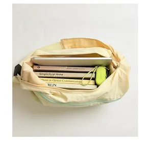 Internal view of a cream minimalist shoulder bag showing its large storage capacity.