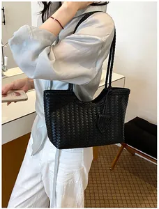 Detailed view of the black woven texture on a stylish and chic tote bag for women