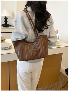 Elegant brown woven texture tote bag shown on model for stylish daily commuting