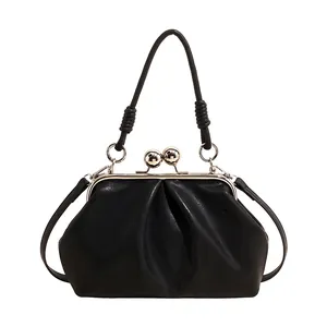 Front view of black pleated cloud handbag featuring kiss-lock closure and top handle
