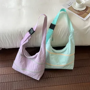 Minimalist pastel nylon shoulder bags with adjustable straps and multi-zipper pockets