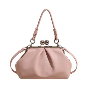 Elegant pink pleated cloud handbag with silver kiss-lock frame and stylish knotted handle