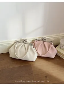 Detailed view of cream and pink pleated cloud clutch bags in a vintage style.