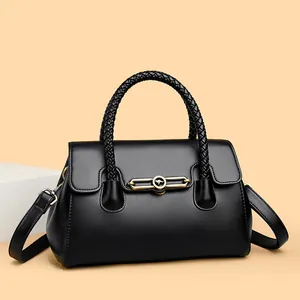 Elegant black top-handle handbag with woven handle and gold-tone kangaroo logo detail