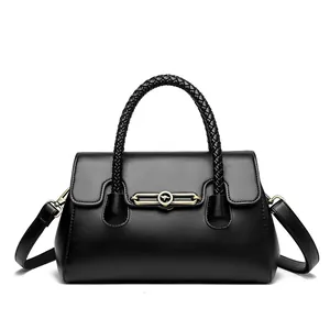 Elegant black women's leather handbag with woven handle and retro gold buckle design