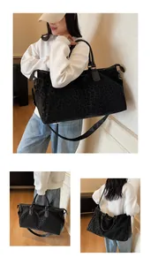 Detailed view of a large leopard print travel bag showing shoulder and hand-carry poses
