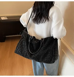 Leopard print travel bag for women shown worn as a shoulder bag in a lifestyle setting