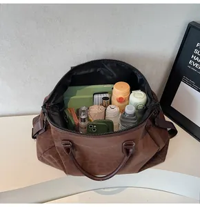 Detailed view showing the massive internal capacity of the leopard print travel bag.