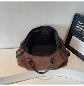 Top view of large capacity leopard print travel duffel bag showing black interior pockets