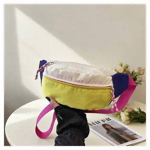 Detailed view of a multi-color dopamine style chest bag with grid texture and pink strap.