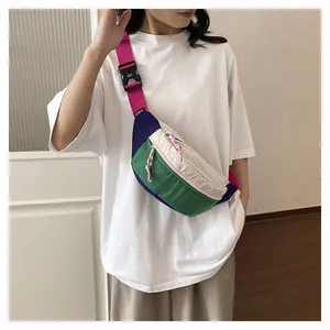 Close-up of a colorful color-blocked dopamine chest bag worn by a model on white shirt