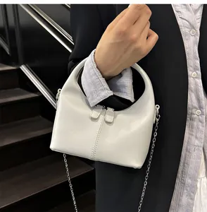 Detail of minimalist white soft PU handbag with elegant silver chain strap