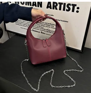 Front view of a burgundy soft PU leather handbag featuring a silver metal chain strap.
