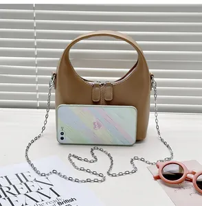 Detail view of retro PU leather handbag with smartphone for size comparison.