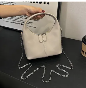 Beige soft PU leather handbag with elegant silver chain strap and top handle.