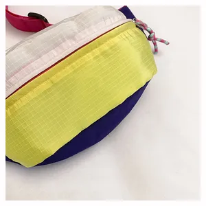 Close-up of lightweight dopamine-style crossbody bag with vibrant color-blocking grid fabric