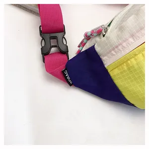 Detail shot of a colorful dopamine style chest bag with grid texture and pink strap