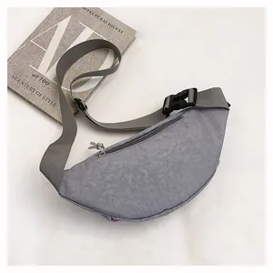 Top view of a minimalist gray nylon crescent chest bag with an adjustable strap