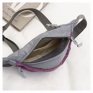 Close-up detail of the inner compartment and zipper of the gray lightweight nylon chest bag