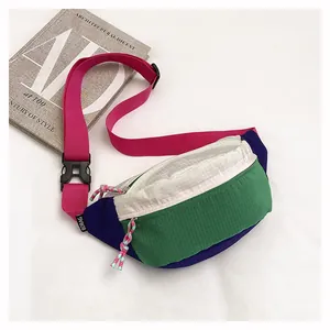 Detailed close-up view of vibrant dopamine colorful nylon chest bag with pink adjustable strap