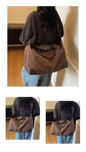 Back view of a person carrying a large retro brown suede travel bag over the shoulder