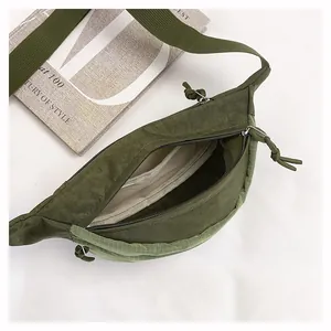 Detailed interior view of a lightweight green nylon crossbody bag with lining.