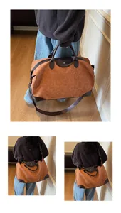 Premium brown suede vintage travel bag displayed in hand and worn as a crossbody