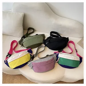 Variety of colorful dopamine-style nylon crossbody waist bags displayed on a white sofa