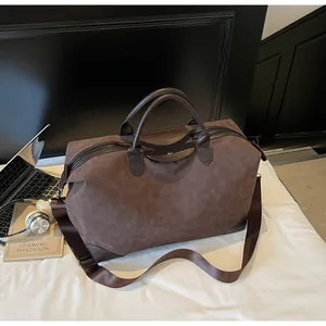 Large brown vintage frosted suede travel bag with leather handles and strap detail